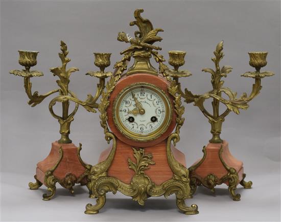 An early 20th century French pink marble clock garniture, 13.5in.